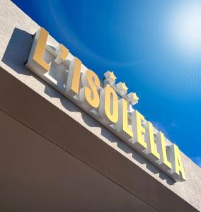 a sign on the top of a building with the word excellence at Hotel l'Isolella in Porticcio