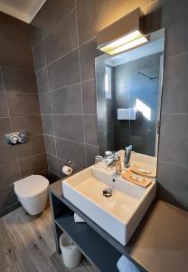 a bathroom with a sink and a toilet at Hotel l'Isolella in Porticcio