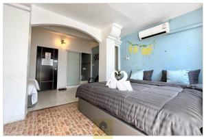 a bedroom with a large bed with swans on it at Hooman Hostel in Chiang Mai