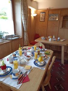 a wooden table with plates of food on it at Gästehaus Alpenblick in Innsbruck