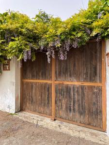 a wooden garage door with a bunch of flowers on it at Villetta 150mt dalla Spiaggia Flumini di Quartu in Flumini di Quartu