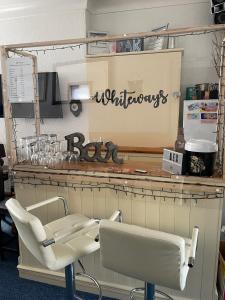 a barber shop with two chairs and a barber shop sign at Whiteways Guest House in Skegness