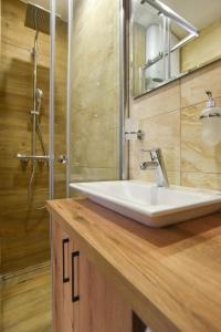 a bathroom with a white sink and a shower at Sambra old town apartment in Budva +15 photos