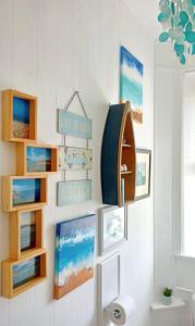 a bathroom with a shelf with pictures on the wall at Unique 2-bedroom Coastal Town Retreat in Kingsbridge