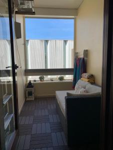 a room with a bed and a large window at Troia Setubal Praia in Troia