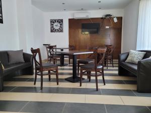 a dining room with a table and chairs at VilLa AdeLe in Siófok