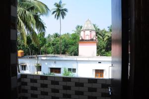 a view from a window of a building with a tower at Aryan residency in Māvalli