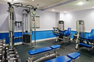 a gym with blue chairs and tread machines at Hamilton Hotel - Washington DC in Washington