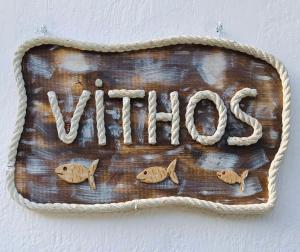 a sign on a wall with fish on it at Vithos in Agnontas