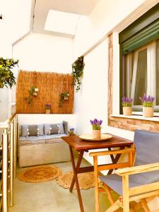 a patio with a wooden table and a couch at Vithos in Agnontas