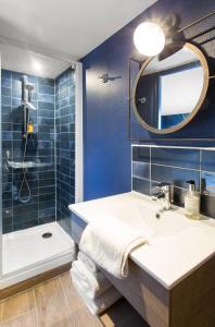 a blue bathroom with a sink and a shower at Hotel Iena in Angers +42 photos