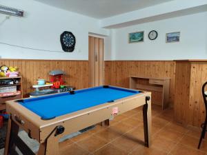 a pool table in a room with wooden walls at Penzion MAYKA in Hrabušice +42 photos