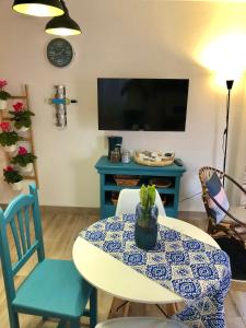 a living room with a table and a tv at Casa Lucilita in Valles de Ortega