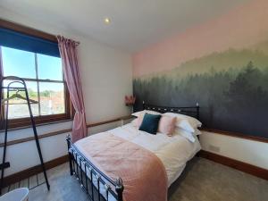 a bedroom with a bed with a painting on the wall at Stylish City Centre Apartment on the Kings Mile in Canterbury