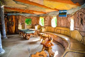 a living room with a stone wall at Lake Elementaita Nature Pebbles & Spar in Gilgil