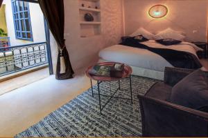 Säng eller sängar i ett rum på Riad La Porte de l'oasis