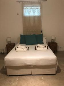 a large bed in a bedroom with a window at Les Cypres in Mougins
