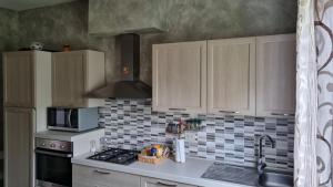 a kitchen with a sink and a stove top oven at Milli in Ferrara