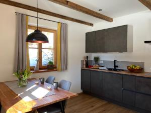 a kitchen with a wooden table and a dining room at Ferienwohnung Sunnseitn in Bayrischzell