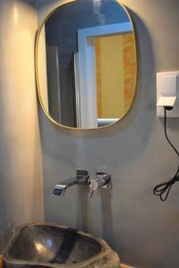 a bathroom with a sink and a mirror at Apartamentos Colmeia in Lisbon