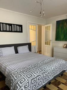 a bedroom with a large bed and a painting at Loft at Bruges in Varsenare