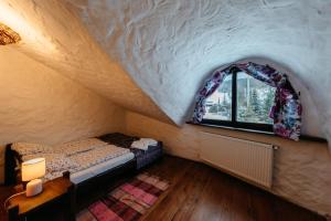 Zimmer im Dachgeschoss mit einem Bett und einem Fenster in der Unterkunft Gęsi Zakręt in Ustrzyki Dolne