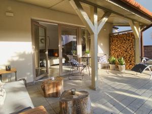 a patio with tables and chairs on a house at Domek Mrągowo in Mrągowo