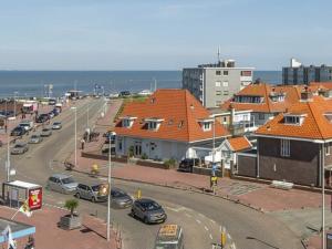 a city with cars parked on a street with buildings at Pension Sissi in Zandvoort