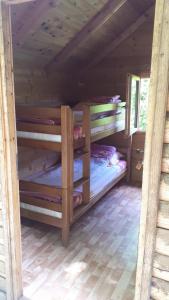 a room with two bunk beds in a cabin at Rafting Kamp Brijeg in Kružac