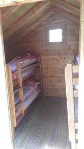 a cabin with two bunk beds and a window at Rafting Kamp Brijeg in Kružac