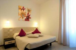 een slaapkamer met een bed met rode kussens erop bij Ara Pacis Inn in Rome