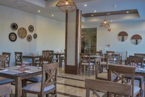 a restaurant with tables and chairs in a room at The Bay Hotel Hurghada Marina in Hurghada