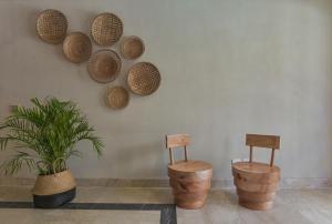 two chairs and baskets on a wall with a plant at AJIRA Bay Hotel Hurghada Marina in Hurghada