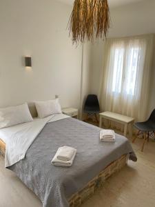 a bedroom with a large bed with two towels on it at Villa Sylvia in Matala