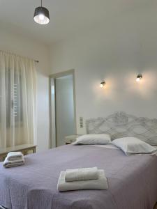 a bedroom with a bed with two towels on it at Villa Sylvia in Matala