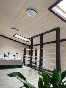 a bedroom with a bed and a ceiling with skylights at Chorna Skelya Resort & Wellness in Vynohradiv