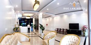 a lobby of adq law hotel with a man standing in the doorway at Đức Lan Hotel in Ha Giang