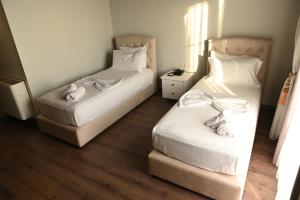 Postel nebo postele na pokoji v ubytování Hotel Onufri