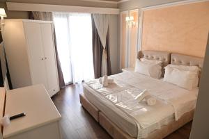 Postel nebo postele na pokoji v ubytování Hotel Onufri