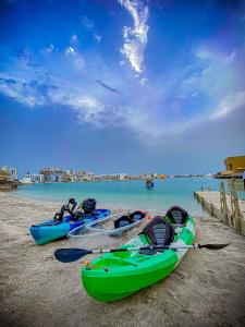 a group of three boats sitting on the beach at Dragon Hotel And Resort in Manama