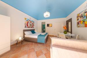 a bedroom with a bed and a table at CATHENA HOLIDAY CEFALU in Cefalù