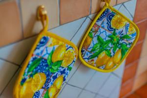 two plates with oranges on them on a tile counter at CATHENA HOLIDAY CEFALU in Cefalù +39 photos