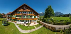 a large house with a fence in front of it at Jägerhof und Jägerstadel in Schwangau