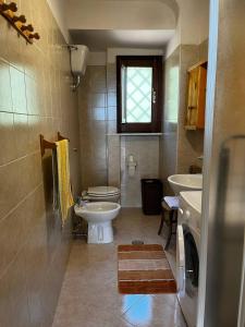 a small bathroom with a sink and a toilet at Casa Maria Host Green - Casa vacanze - Rossano in Case San Francesco +24 photos