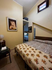 a bedroom with a bed and a table and a window at Casa Maria Host Green - Casa vacanze - Rossano in Case San Francesco