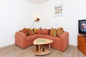 ein Wohnzimmer mit einer Couch und einem Tisch in der Unterkunft Pension Pradler Wohnung 2 in Carolinensiel