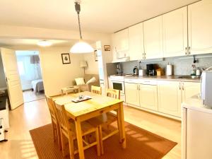 a kitchen and dining room with a wooden table at Kuivaketveleen Piha in Lappeenranta