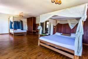 Een bed of bedden in een kamer bij Eulophiella