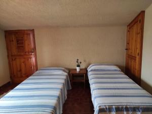 dos camas sentadas una al lado de la otra en una habitación en La Mansarda, en Ceglie Messapica