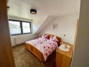 a small bedroom with a bed and a table at Apartment Anita in Bottrop